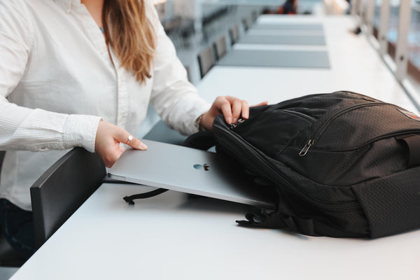 A person putting a laptop into a Spectron Synik 26